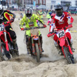 Riders competing at Weymouth Beach Motocross on the Dorset coast